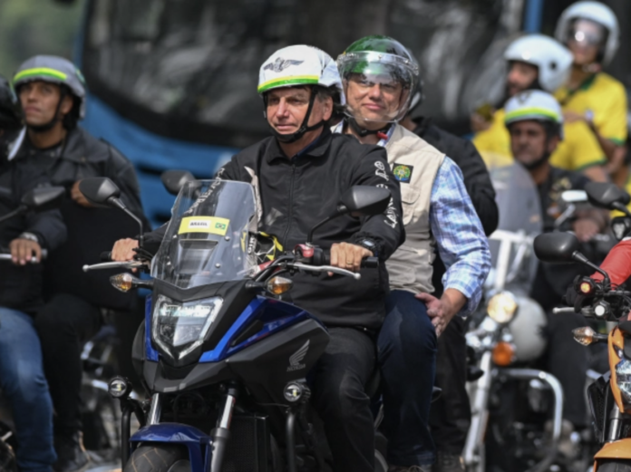 Brazilian President Jair Bolsonaro heads a motorcade rally with his supporters in Rio de Janeiro on May 23