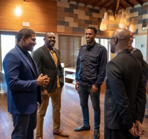 PM Terrance Drew engaging in a conversation with Footballer Claude Makélélé