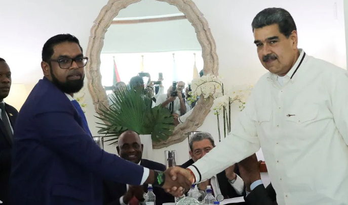 Venezuela's President Nicolas Maduro and Guyanese President Irfaan Ali shake hands as they meet amid tensions over a border dispute, in Kingstown via REUTERS.