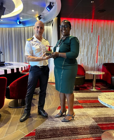 Captain Massimo Penisi and Officer in Charge at ACP- Cynthia Jacobs Browne during gift exchange. (Credits: Antigua Breaking News, Facebook)