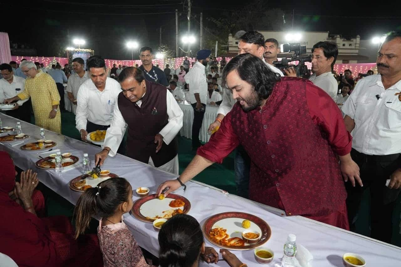 Mukesh Ambani and his son, Anant Ambani served food to villagers ahead wedding. (Credits: Nita Ambani, Facebook)